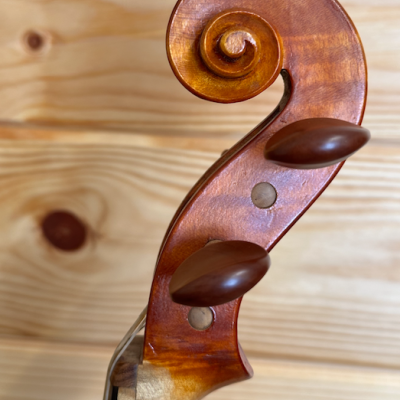 Cabeça de violino de madeira castanha com pinos castanhos escuros