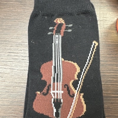 Meia preta com padrão de violino e arco bordados em cores castanho e branco