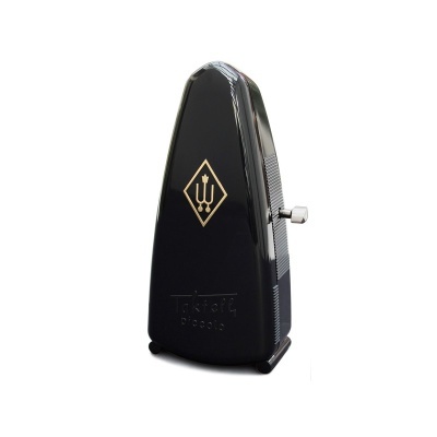 Metrónomo preto com símbolo dourado e botão prateado