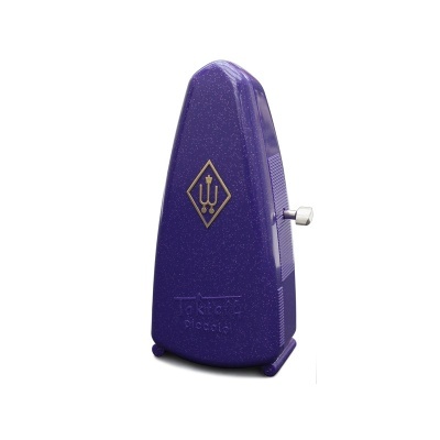 Metrónomo roxo com símbolo dourado e chave metálica lateral