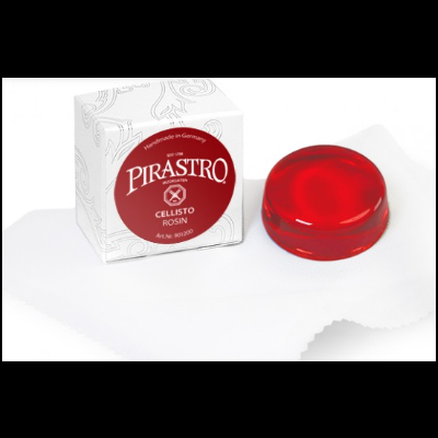 Caixa branca com etiqueta vermelha ao lado de bloco circular vermelho numa pano branco