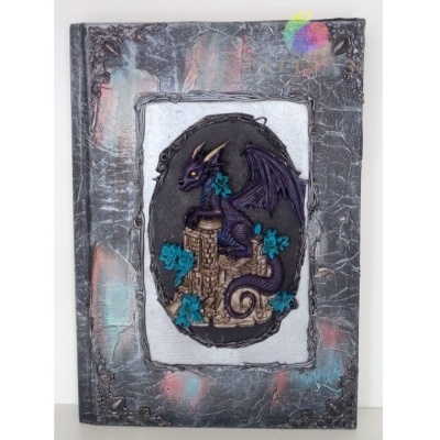 Livro com capa decorada com dragão em relevo