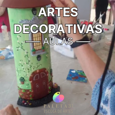 Vaso decorativo pintado à mão com casa e flores e texto promocional de aulas de artes decorativas