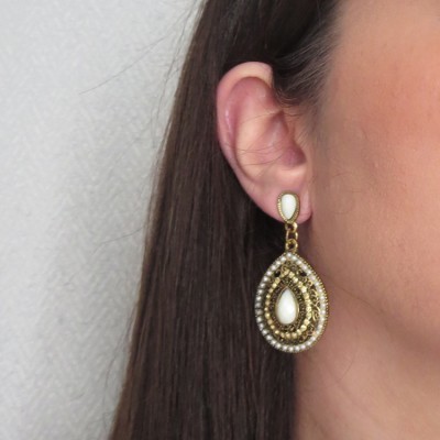 Brincos pendentes dourados com pérolas e pedras brancas em orelha