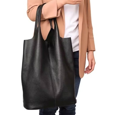 Bolsa preta grande de couro usada ao ombro