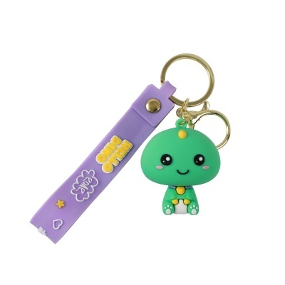 Chaveiro com figura de dino verde e fita roxa com texto e desenhos