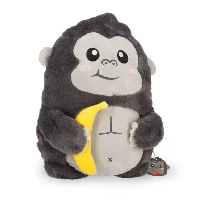 Peluche macaco cinzento segurando banana amarela