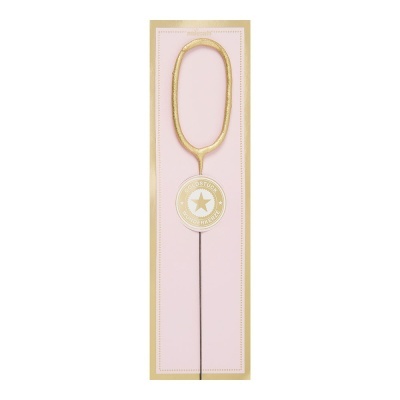 Vela dourada formato número zero em cartão rosa claro