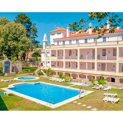 Piscina exterior com espreguiçadeiras e edifício branco ao fundo