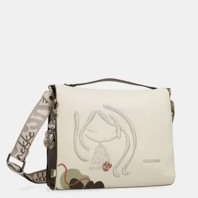 Mala creme com ilustração de rosto e alça de tecido com padrão