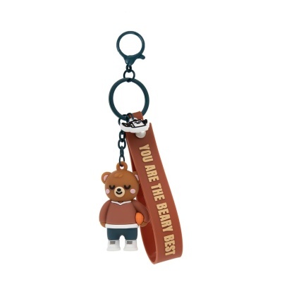 Chaveiro de urso castanho com tira castanha com texto e argolas pretas