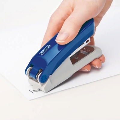 Máquina de grampos azul e cinzenta a grampear papel branco em fundo claro