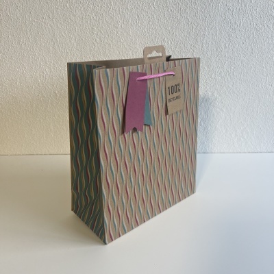 Saco de papel reciclado com padrão geométrico e etiquetas coloridas