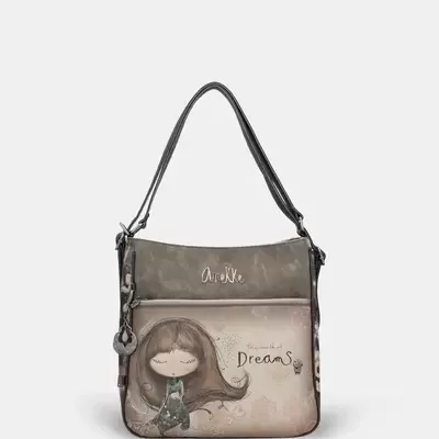 Mala de ombro bege e castanha com ilustração de menina e texto Dreams.