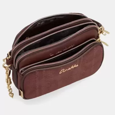 Bolsa castanha com três compartimentos e puxadores de zíper dourados em forma de coração