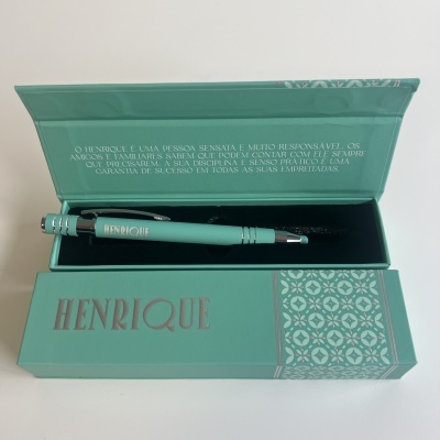 Caneta verde água na caixa verde água com nome Henrique e texto