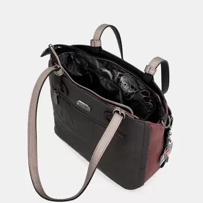 Bolsa de ombro preta e castanha com asas cinzentas e interior com padrão de flores