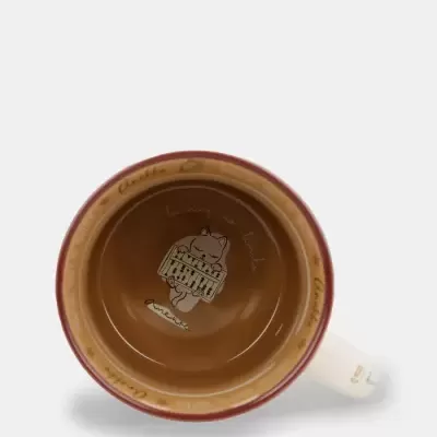 Vista interior de caneca castanha com ilustração de gato e texto