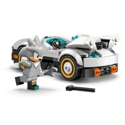 Brinquedo LEGO carro desportivo branco com figura cinzenta e peça preta no chão