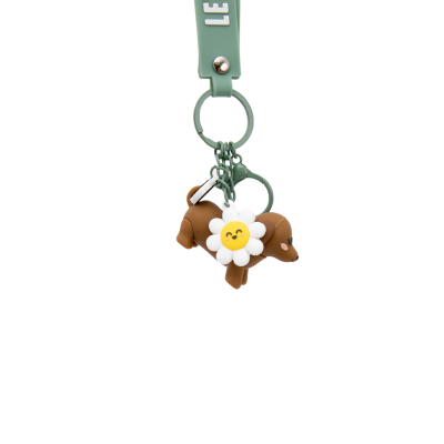 Chaveiro verde com cão castanho e flor sorridente de silicone