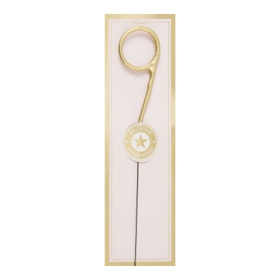 Vela dourada em forma de número 9 com selo e embalagem branca e dourada