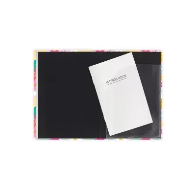 Livro de endereços aberto com capa floral colorida e página preta visível.