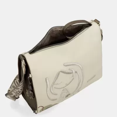 Mala de ombro bege com bordado de rosto feminino e alça larga com padrão