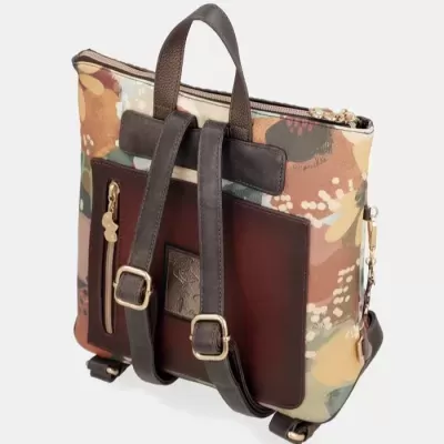 Mochila com padrão floral em tons de castanho, bege, verde e caramelo e alças em pele castanha