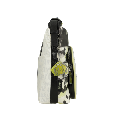 Mala de ombro preta e branca com padrão de manchas e chaveiro amarelo