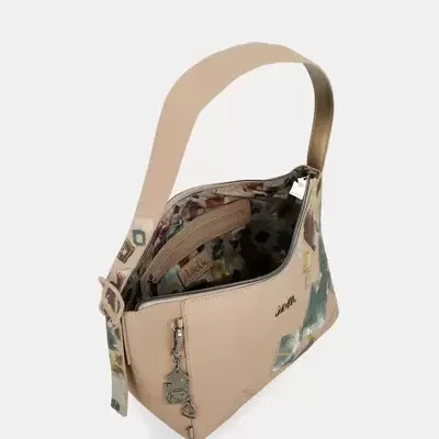 Mala de ombro bege com padrão colorido abstrato e interior floral