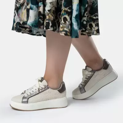 Ténis bege com detalhes cinzentos metálicos e saia plissada colorida