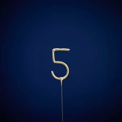 Vela dourada em forma do número 5