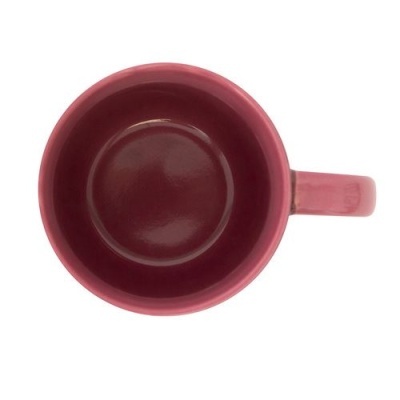 Caneca de cerâmica rosa vista de cima com asa à direita