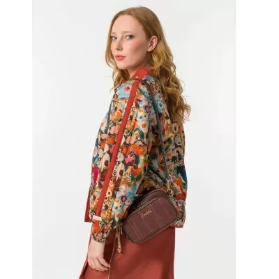 Mulher com casaco colorido floral e mala castanha Anekke