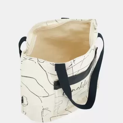 Mala tote de tecido cru com padrão de linhas pretas e brancas e alças negras