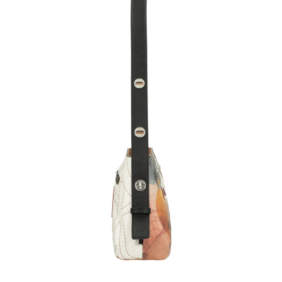 Bolsa branca com padrão de folhas e alça preta vista de lado