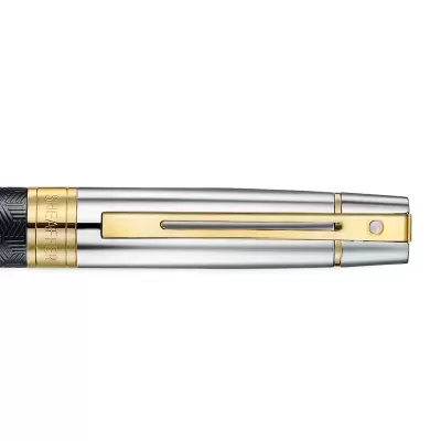 Caneta metálica prateada com clip e detalhes dourados e padrão geométrico preto