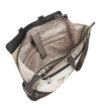 Mala de mão bege e castanha aberta com interior forrado com padrão com texto Anekke.