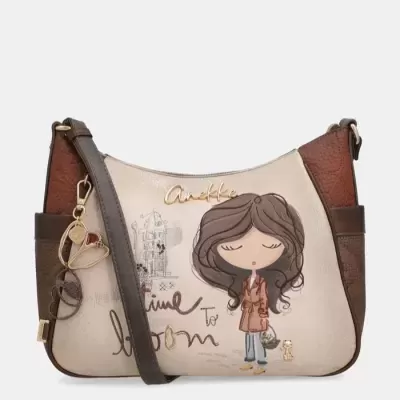 Mala tiracolo bege e castanha com desenho de mulher e texto Time to bloom