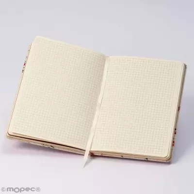 Caderno aberto com páginas quadriculadas e capa floral