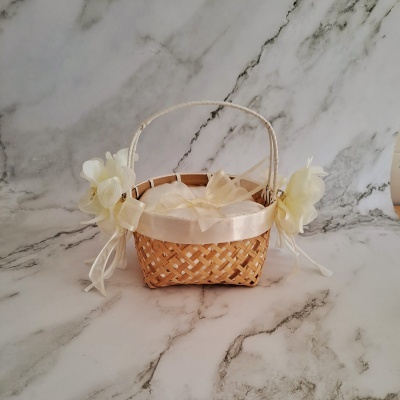 Cesto pequeno em vime com decoração creme sobre mármore claro