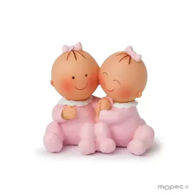 Bonecos de bebés gémeos em roupas rosas com laços cor-de-rosa