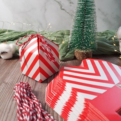 Caixa de presente vermelha e branca com lã, mini árvore de Natal e tecido verde