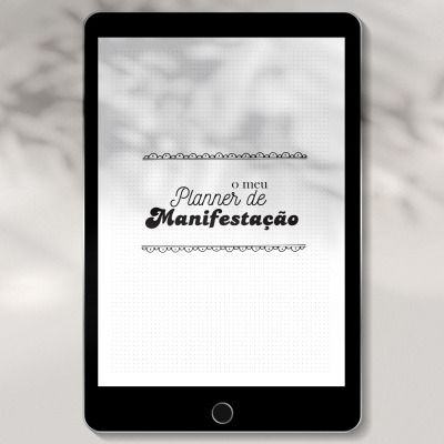 Tablet preto com texto 'o meu Planner de Manifestação' em fundo branco pontilhado