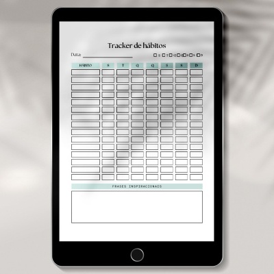 Tablet a mostrar um Tracker de hábitos num ecrã branco com tabelas e espaços para datas, signos e observações.