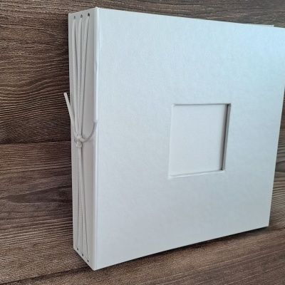 álbum de fotografias branco com capa texturizada e recorte quadrado