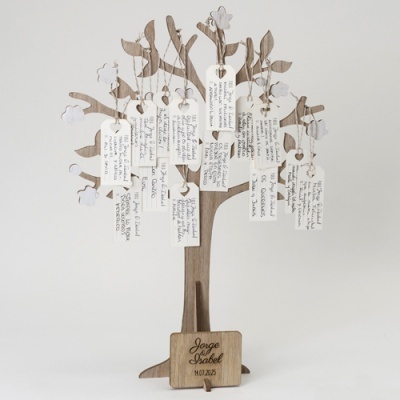 Árvore decorativa em madeira com placas penduradas e texto manuscrito