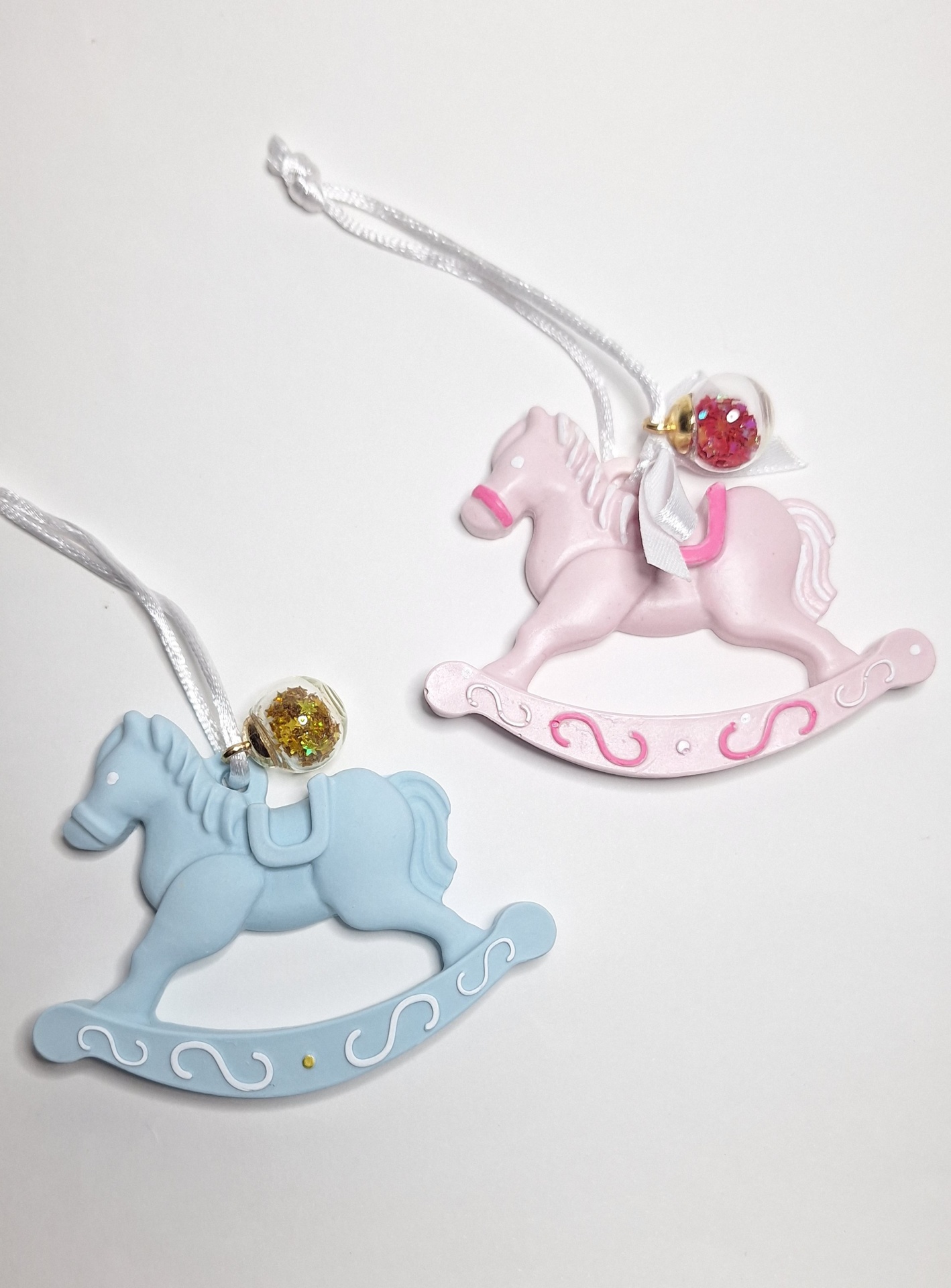 Pendente Cavalinho Dois enfeites de cavalo de balanço azul e rosa com bonecos e purpurina