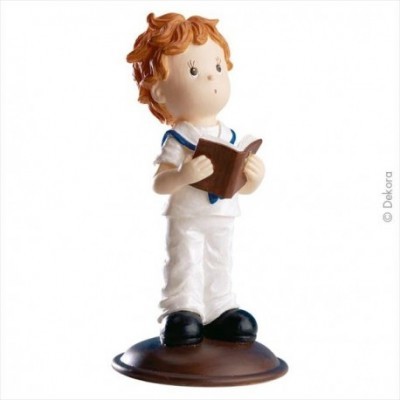 Figura decorativa de criança com cabelo ruivo a ler um livro
