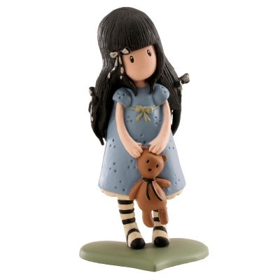 Estátua de menina com vestido azul e urso de peluche